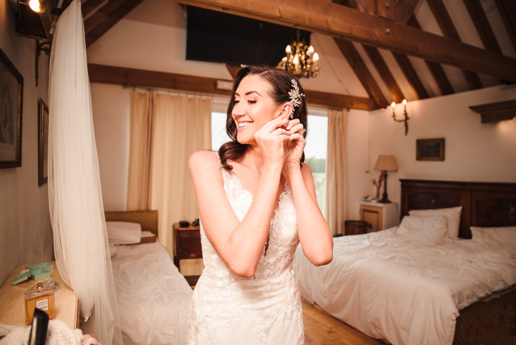 Bride putting her earrings during bridal prep