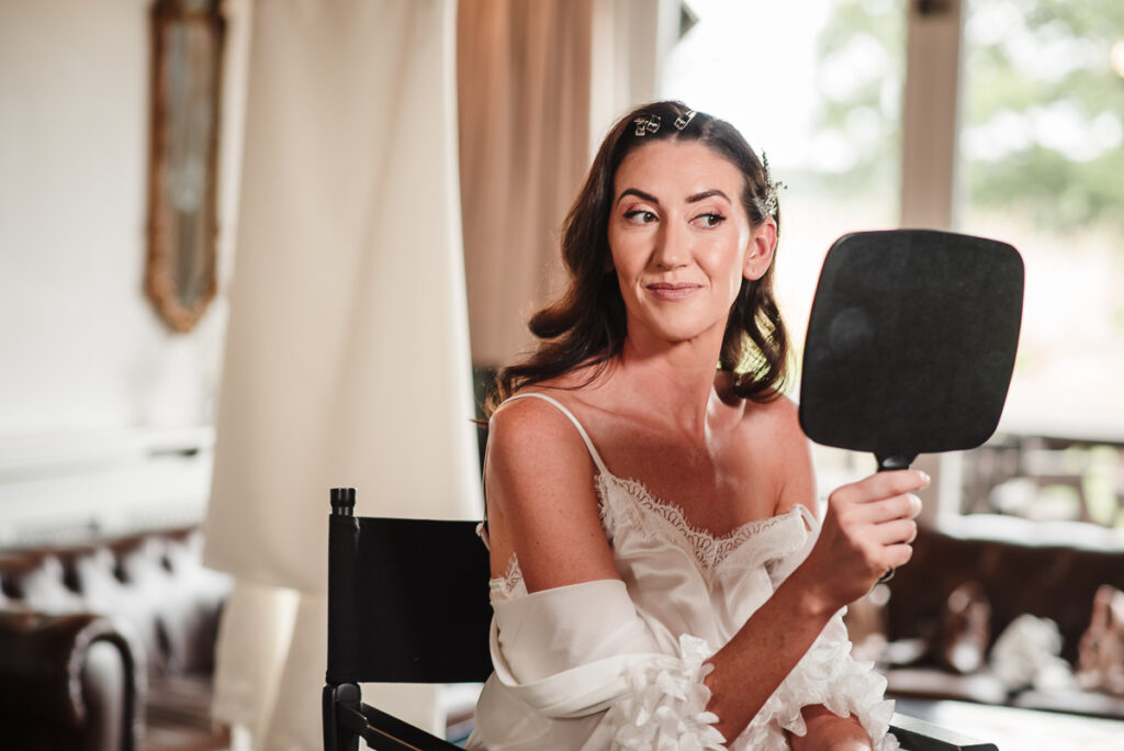 Bride with makeup checking in the mirror