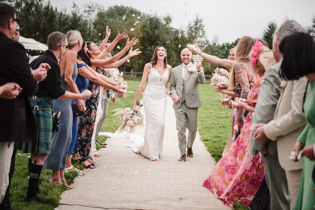 Bride and groom through confetti