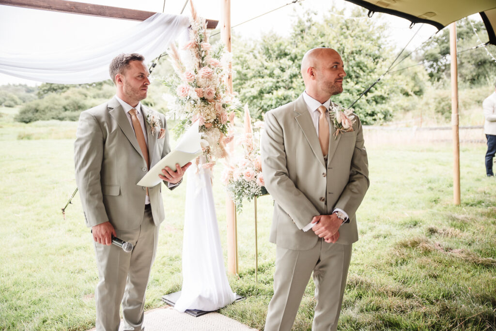 Groom waiting for the bride on the aisle