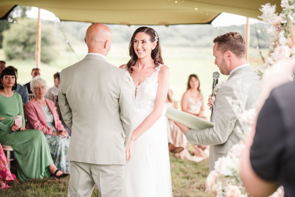 Bride and groom holding hand at the ceremony