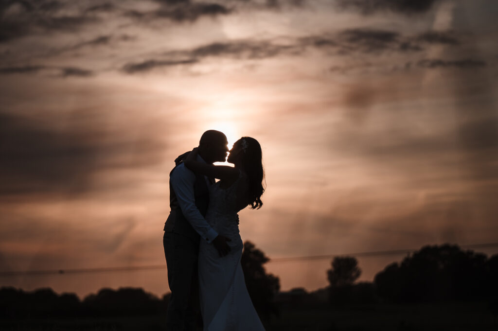 Bride and groom as silhouette during the sunset photos