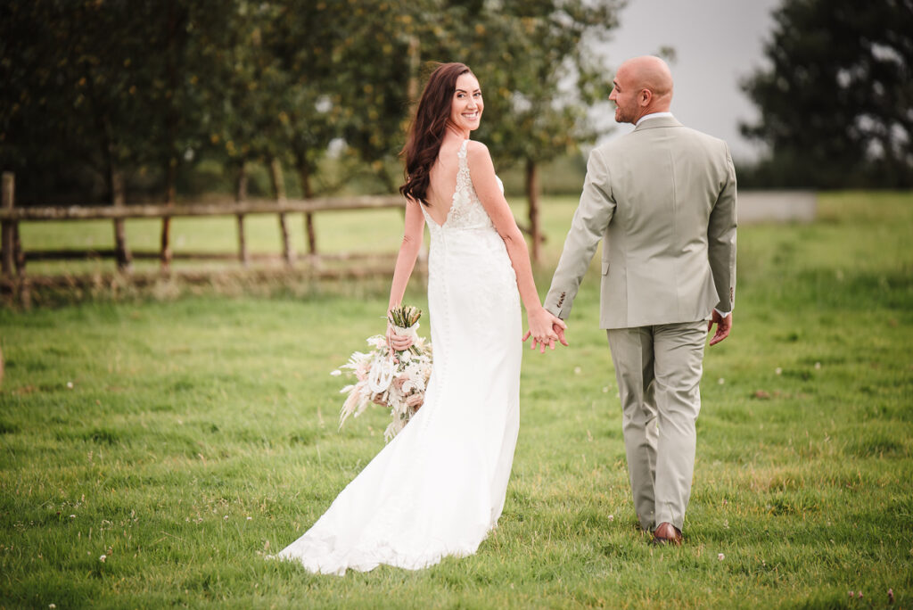 Bride and groom walking during the evening photos