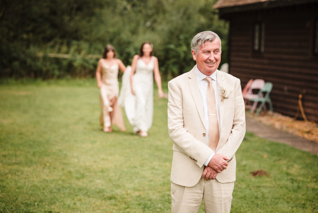 Father of the bride waiting during first look