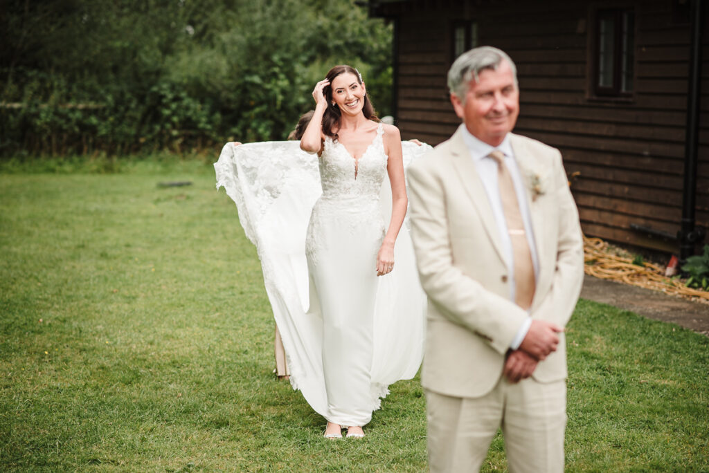 Bride walking toward her father during the first look