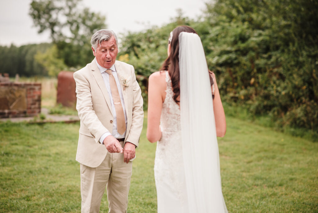 Father of the bride reaction during the first look