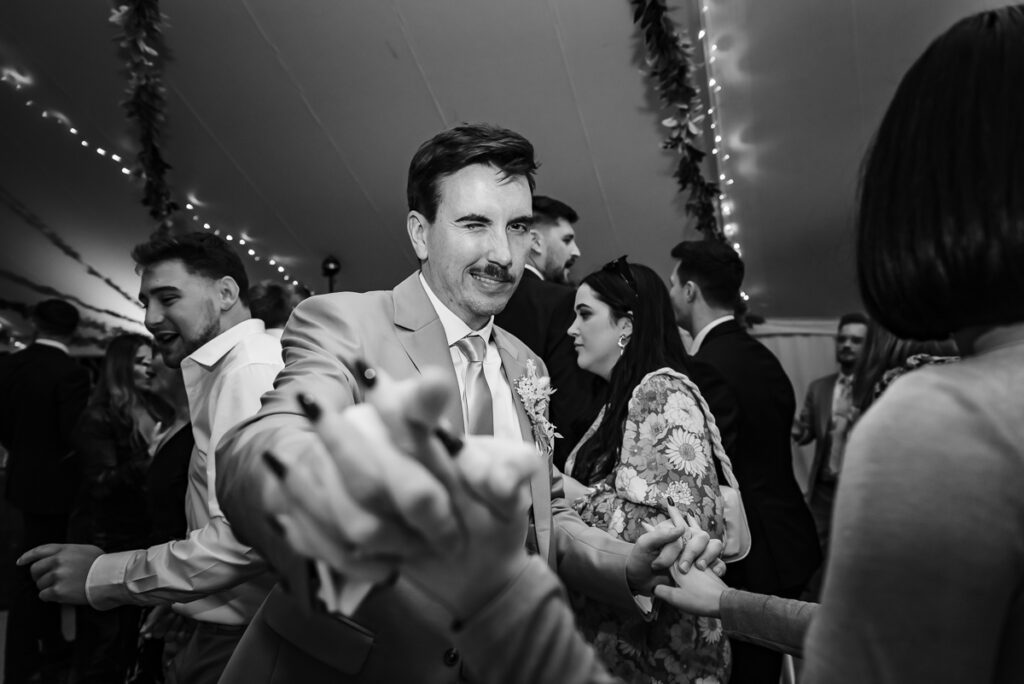 Guest winking and pointing at camera on the dance floor