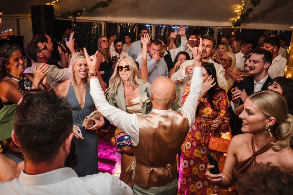 Groom telling the guests to join the dance floor after the first dance